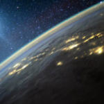 satellite view of the curve of the Earth, with a galaxy of stars in the background