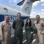NASA team members standing in front of a small aircraft