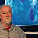 Brad Pierce with a satellite image of the midwestern U.S. in the background