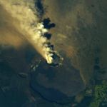 Aerial view of a Hawaiian volcano emitting smoke into the atmosphere