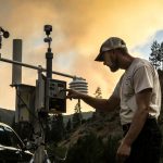 Air resource advisor setting up a temporary smoke monitor in Idaho