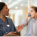 Nurse helping asthmatic child